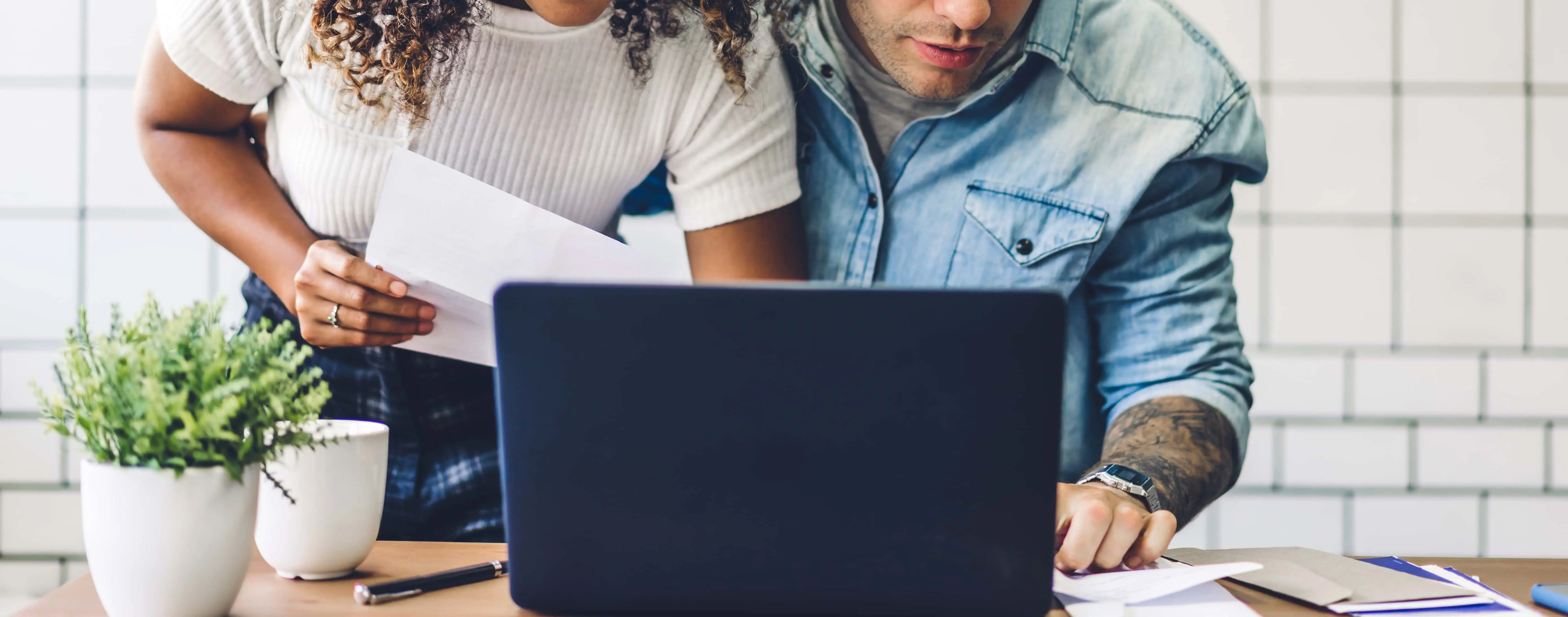 Couple using laptop to fill out an online mortgage application from Blackhawk Bank & Trust