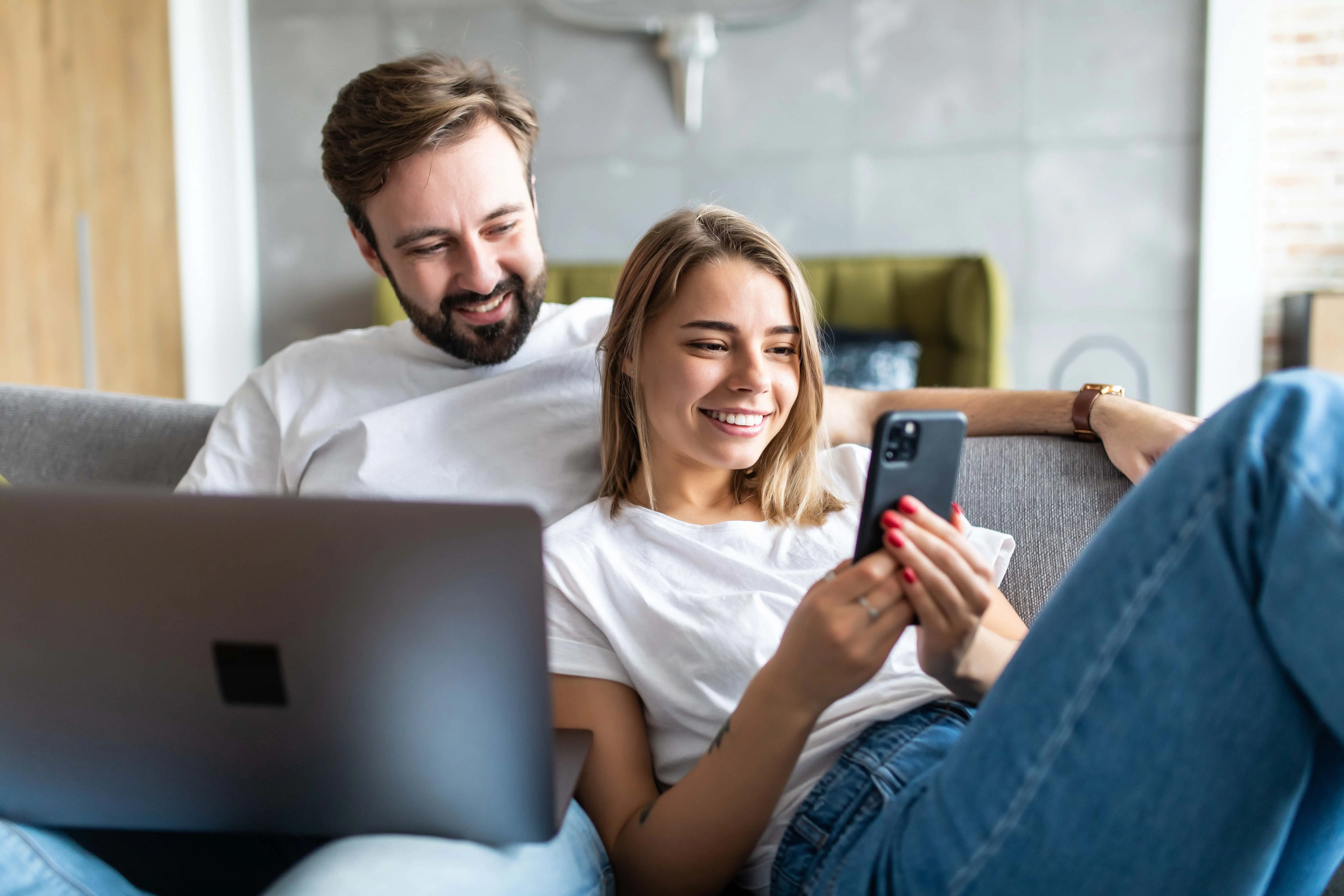 Couple looking at phone to open a Blackhawk Bank & Trust Checking Account