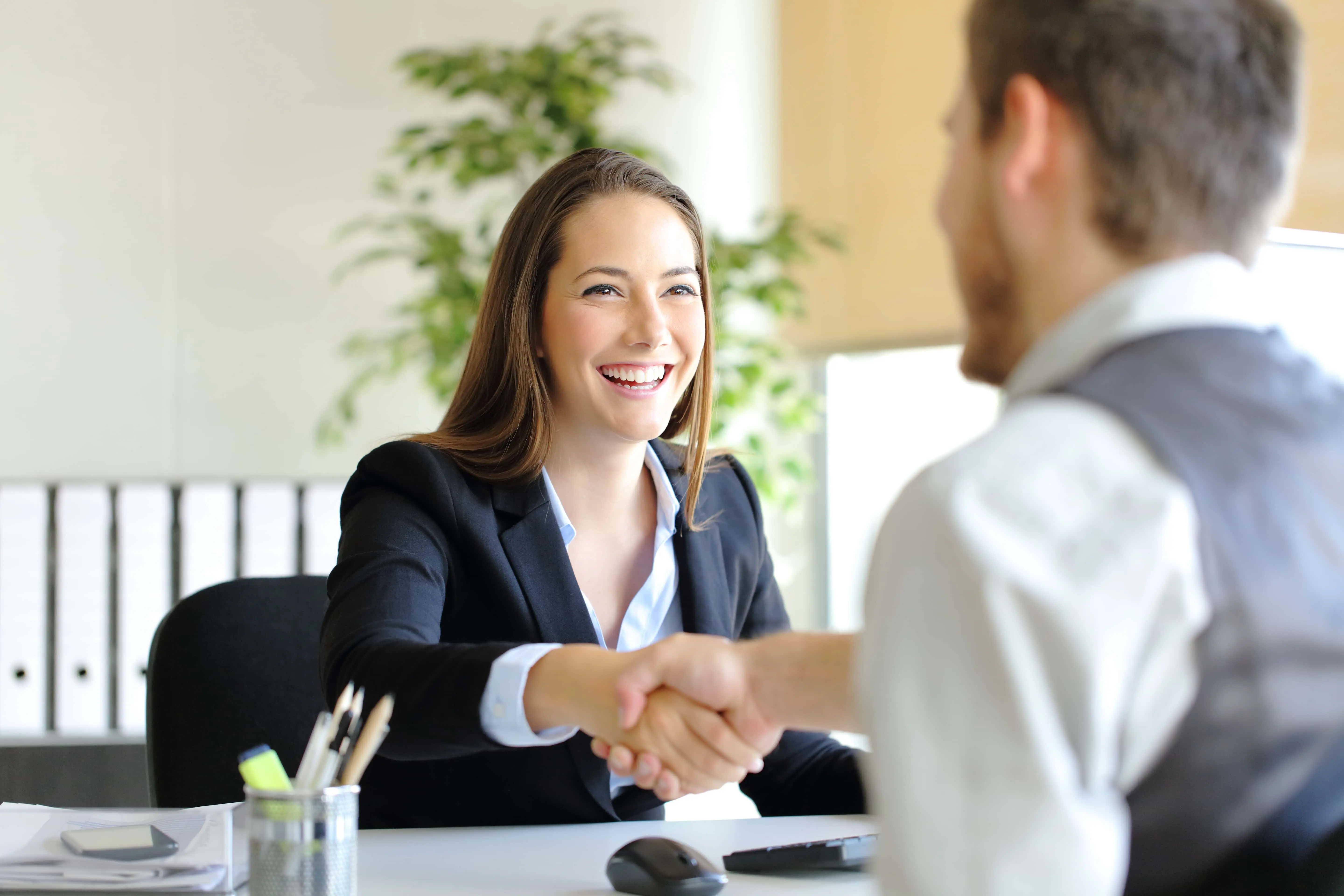 Woman doing an interview of a candidate for a job at a bank